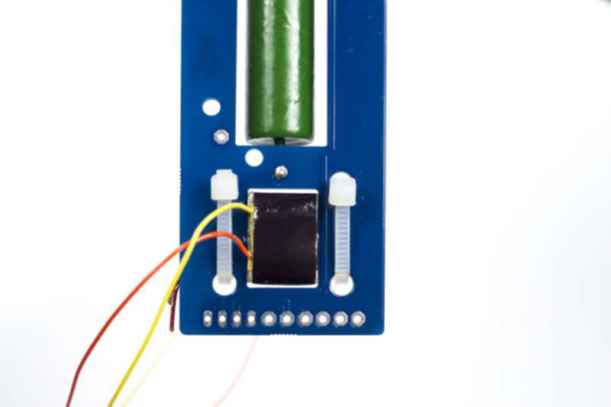 Orange and yellow CM-13114 secondary wires routed to the back of the PCB assembly.